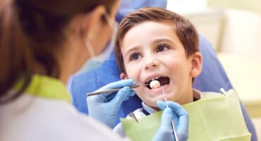 A child with a dentist in a dental office.